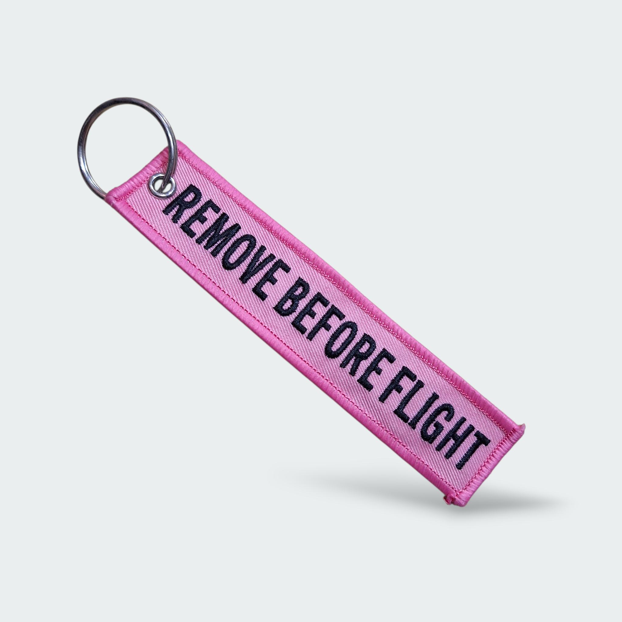 LLAVERO REMOVE BEFORE FLIGHT ROSADO