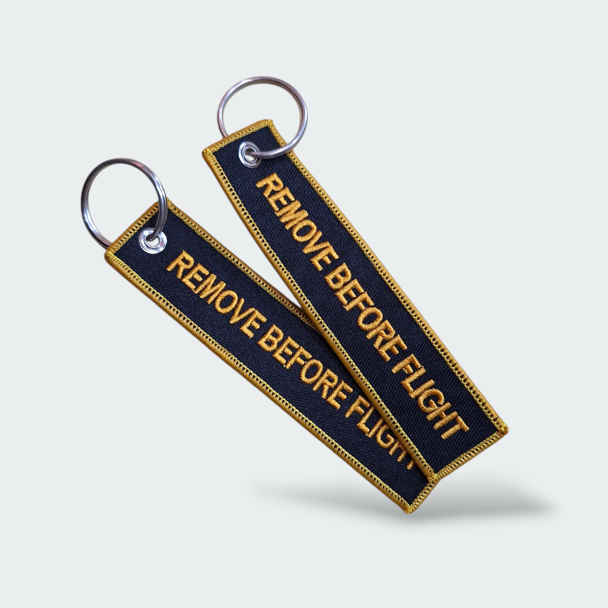 LLAVERO REMOVE BEFORE FLIGHT NEGRO AMARILLO